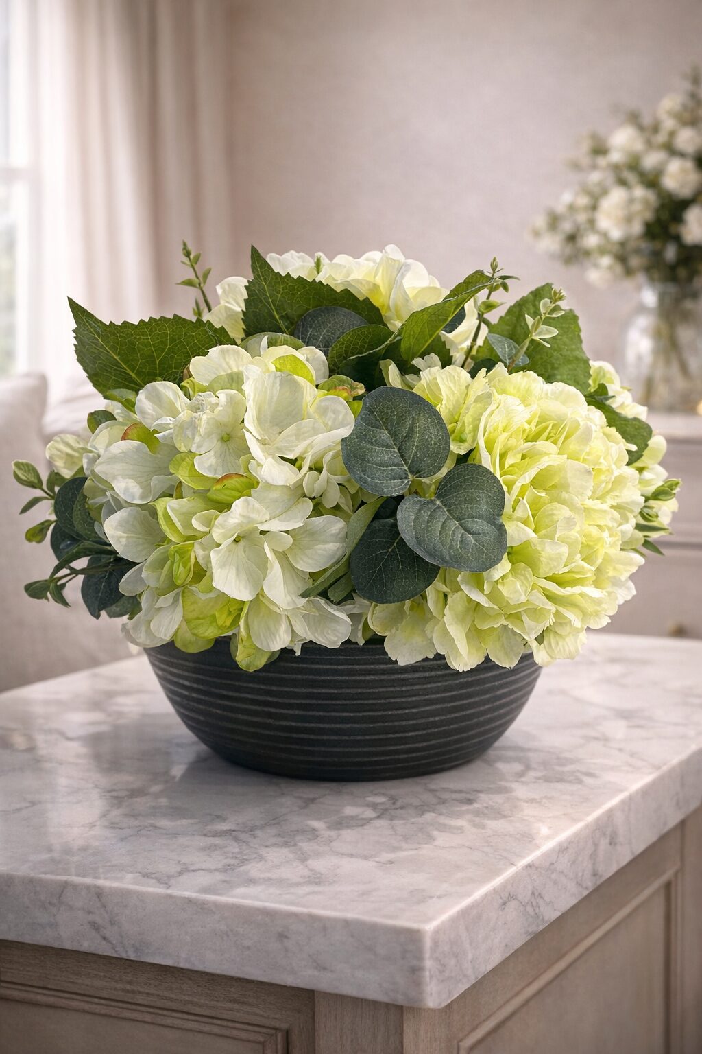 Cream and green faux hydrangea arrangement in a ribbed charcoal bowl