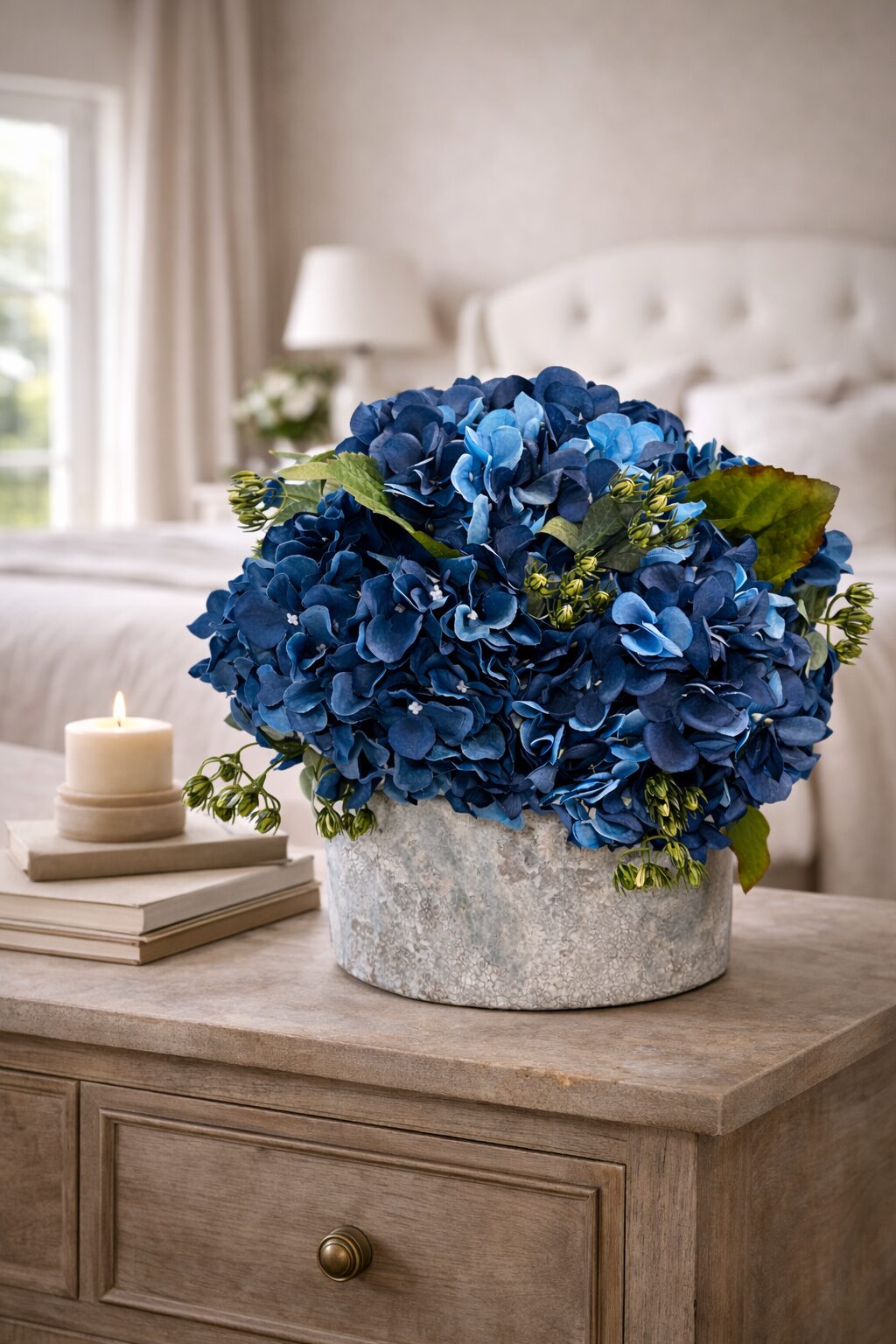 Navy faux hydrangea arrangement in a weathered stone pot