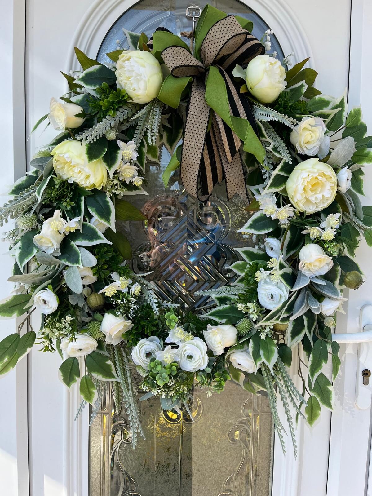 Handmade faux door wreath with white peonies, roses and ranunculus and a striped bow